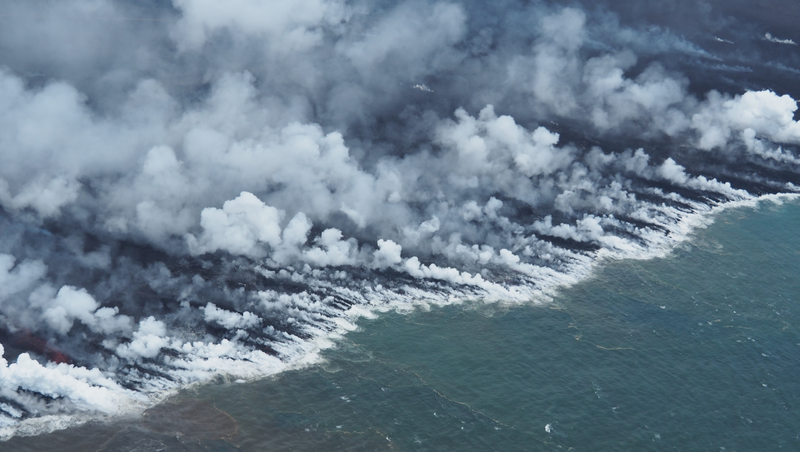 Steam produced by molten lava pouring into the North Pacific Ocean.